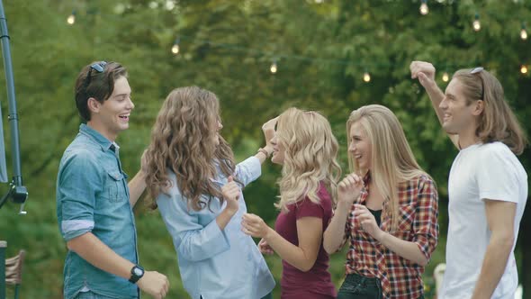 Happy Friends Dancing, Having Fun And Enjoying Party Outdoors.