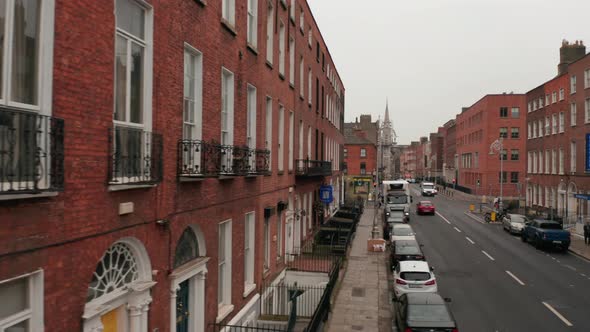 Slider From Brick House Wall to Centre of Narrow Street with Church at End