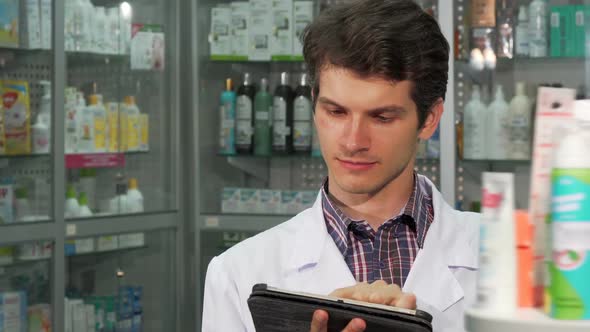 Professional Pharmacist Doing Inventory Using Digital Tablet