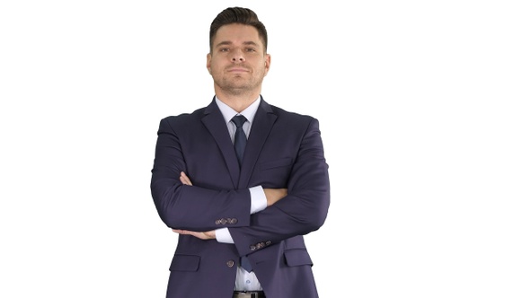 Businessman with folded hands looking to camera on white