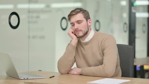 Creative Young Man Taking Nap in Office