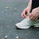 Woman Ties Her Shoelaces on Her Sneakers - VideoHive Item for Sale