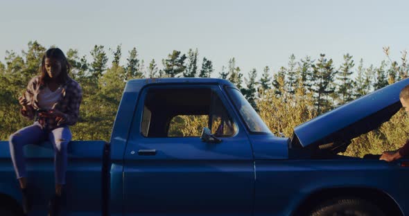 Young couple on a road trip in their pick-up truck