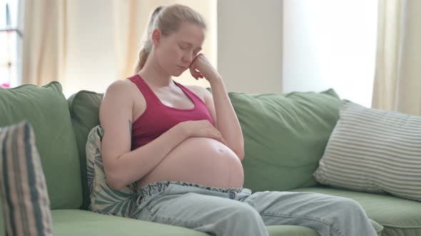 Pregnant Woman Sleeping While Sitting on Sofa