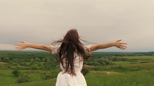 Young Free Woman Standing on Top of Mountain Enjoying Beautiful Sky Impending Storm