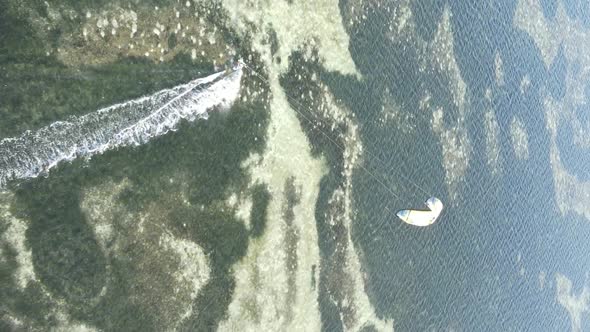 Vertical Video Kitesurfing Near the Shore of Zanzibar Tanzania Aerial View