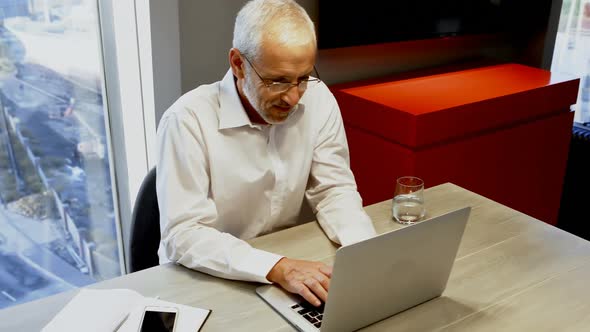 Businessman using laptop in hotel room