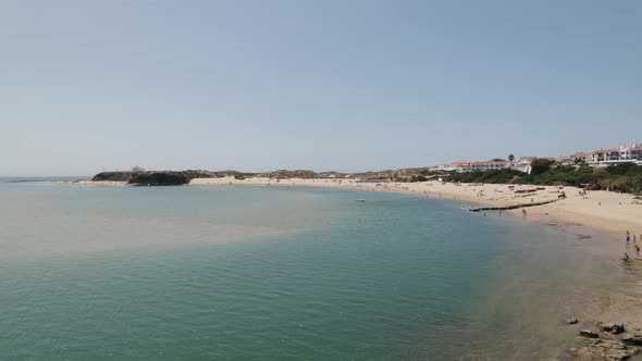 Vila Nova de Milfontes by Mira River, Scenic seascape, Aerial Pullback. Portugal