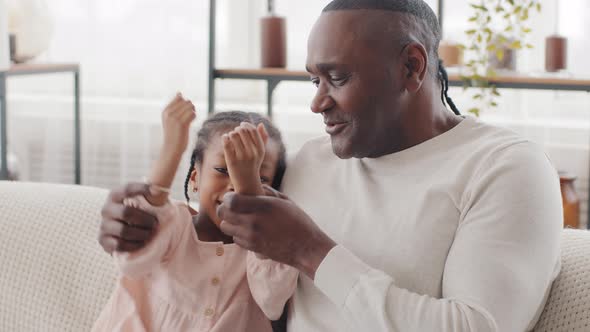 Little Cute Black Girl Daughter Granddaughter Child Kid Baby Sitting on Couch with Afro Father