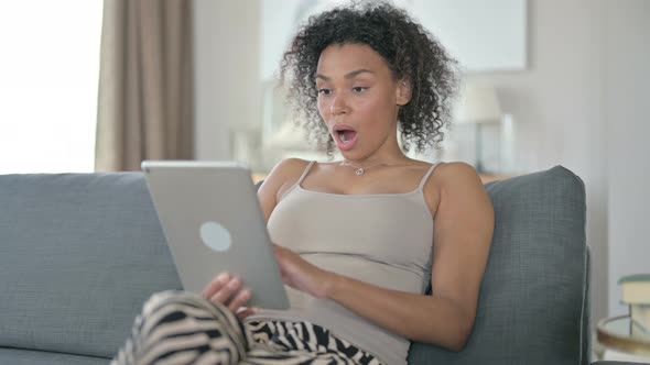 African Woman Reacting To Failure on Tablet at Home