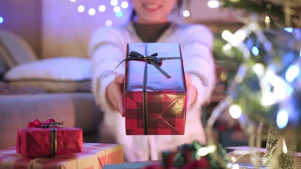 close-up asian female hand present sending present gift box red color