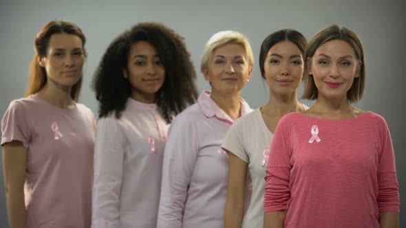 Group of Women Wearing Pink Clothes and Ribbons