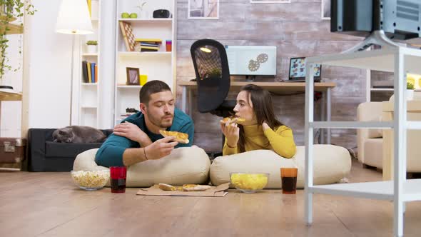 Zoom in Shot of Young Couple Sitting on Pillows