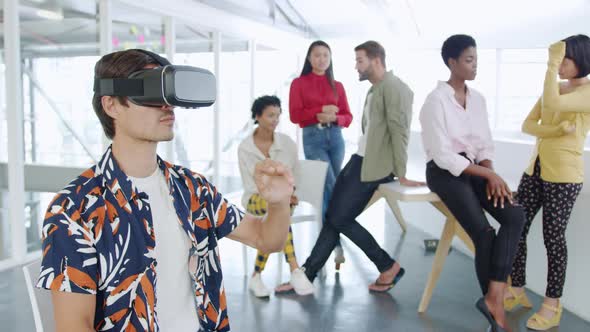 Male creative using VR headset in a modern office