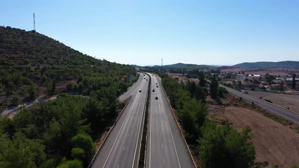 The Car Drives on the Highway Among the Mountains