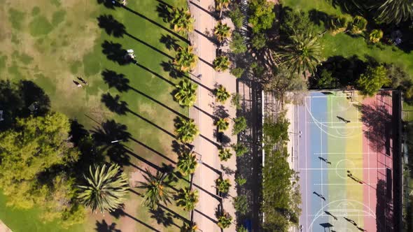 Overhead view over Ines de Suarez Park with people walking and trees in the background