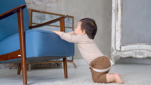 Toddler Baby is actively trying to get up and take first step. 