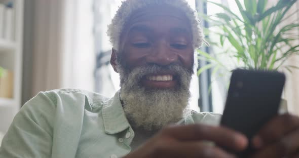 Video of african american senior man using smartphone