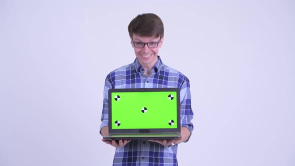 Happy Young Hipster Man Showing Laptop and Looking Surprised