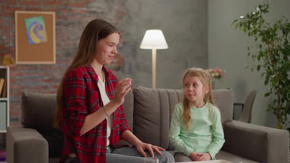 Smiling Girl Shakes Bottle for Ebru Drawing with Sister