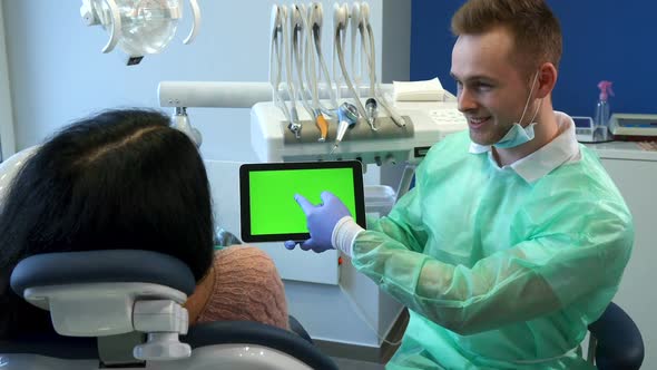 Dentist Points His Hand on Tablet Screen