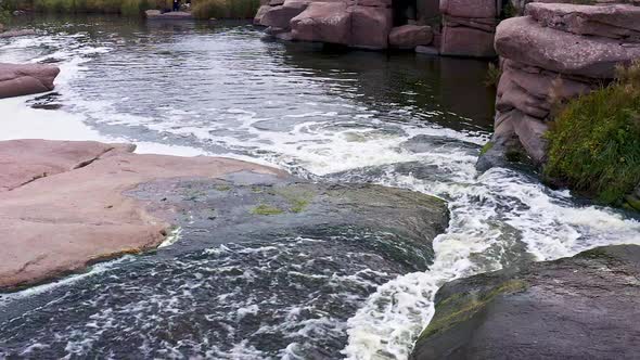 A Fast Stream Among Smooth Dark and Wet Stones