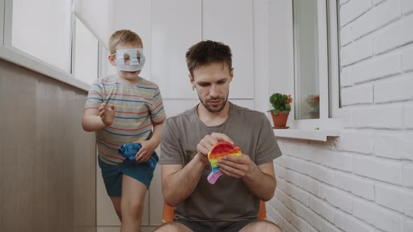 Dad Sit on Balcony and Play Antistress Toy