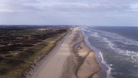 Aerial view over the Dunes of Langevelderslag in Noordwijk coastline, the Netherlands, on a cloudy d