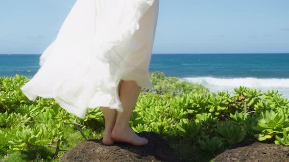 Close Up Woman Slim Barefoot Legs in White Dress Standing on Top Tropical Beach