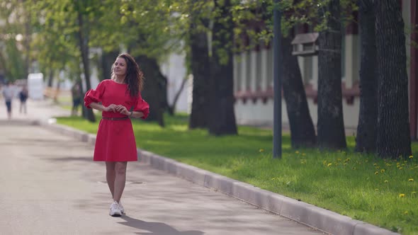 Young Woman is Enjoying Good Weather and Freedom at Summer Vacation