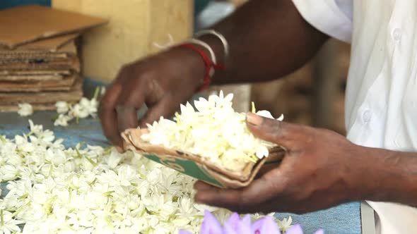 KANDY, SRI LANKA - FEBRUARY 2014: The close up view of a local man arranging floral arrangements. Ka