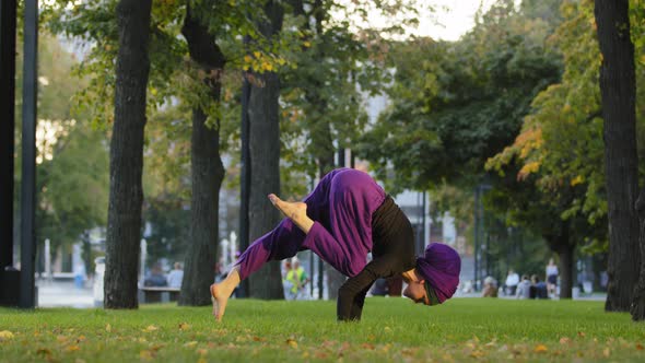 Strong Active Muslim Girl in Hijab Woman Yogi Sportswoman Doing Yoga Workout in Park on Green Lawn