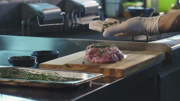 Professional Chef Adding Spices on Pork Meat Before Cooking