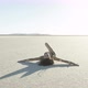 Girl sitting on the dry lake in the desert - VideoHive Item for Sale
