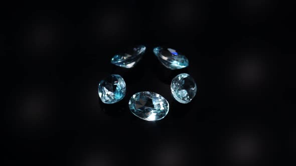 Natural Blue Topaz Gemstones on the Dark Background Turning Table