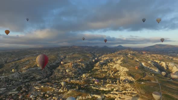 Aerial Hot Air Balloons Flying Over Hoodoos and Fairy Chimneys in Goreme Valley Urgup, Turkey