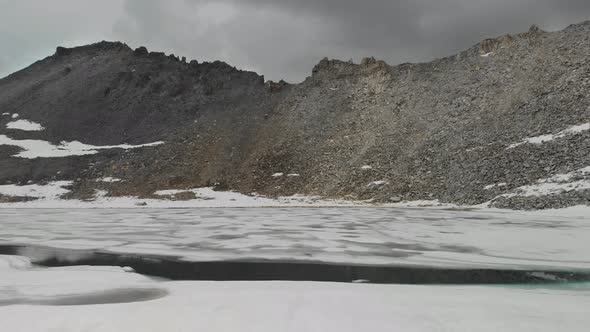 Aerial View of Mountain Lake with Ice and Snow