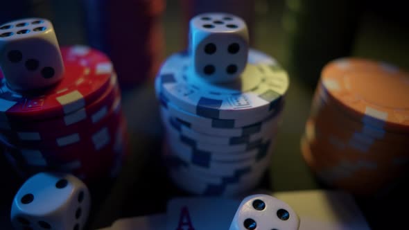 Casino Chips with Dice and Playing Cards on a Dark Table