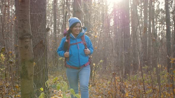 Concept of Winter, Autumn Travel and Hiking. Woman Hiking in Autumn Forest