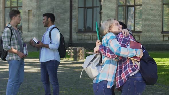 Two Beautiful Female Friends Hugging Near Campus, Long-Awaited Appointment