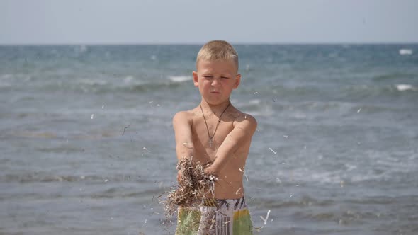 Beach Summer Vacation. Children's Emotions. The Child Develops Tinsel in the Wind.