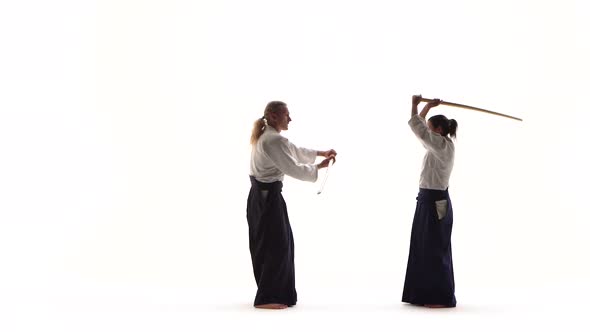 Man, Woman Demonstrating Aikido Using Bokken. Isolated, White. Close Up