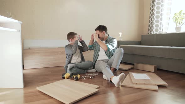 Father and Son Have Fun and Play with Fittings Like Camera and Making Photos