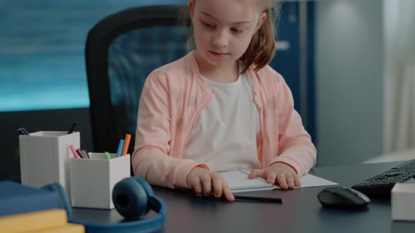 Close Up of Schoolgirl Using Pens and Pencils to Write on Notebook