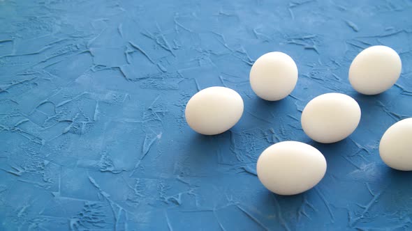 White Eggs Lie on a Blue Table