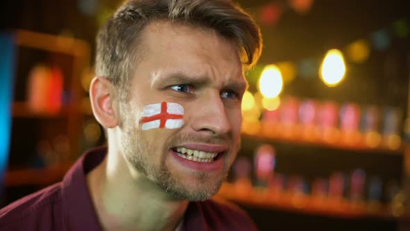 Fan With English Flag Painted on Cheek Unhappy With Team Losing Match, Failure