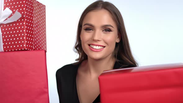 Closeup Portrait Overjoyed Brunette Fashion Woman Posing Heap of Red Wrapped Gift Boxes Isolated