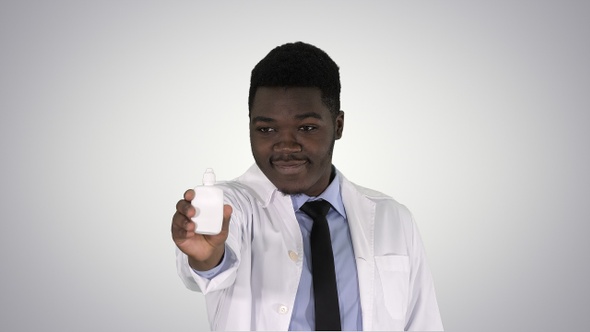 Afro american doctor presenting nasal spray on gradient background.