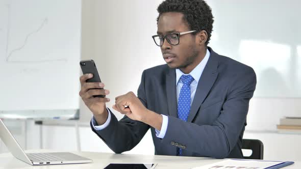 African Businessman Using Smartphone, Text Messaging