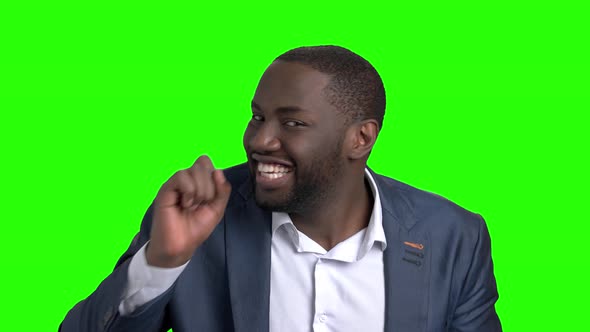 Playful Dark-skinned Businessman on Green Screen.